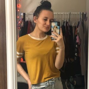 yellow top with white stripes on the sleeves